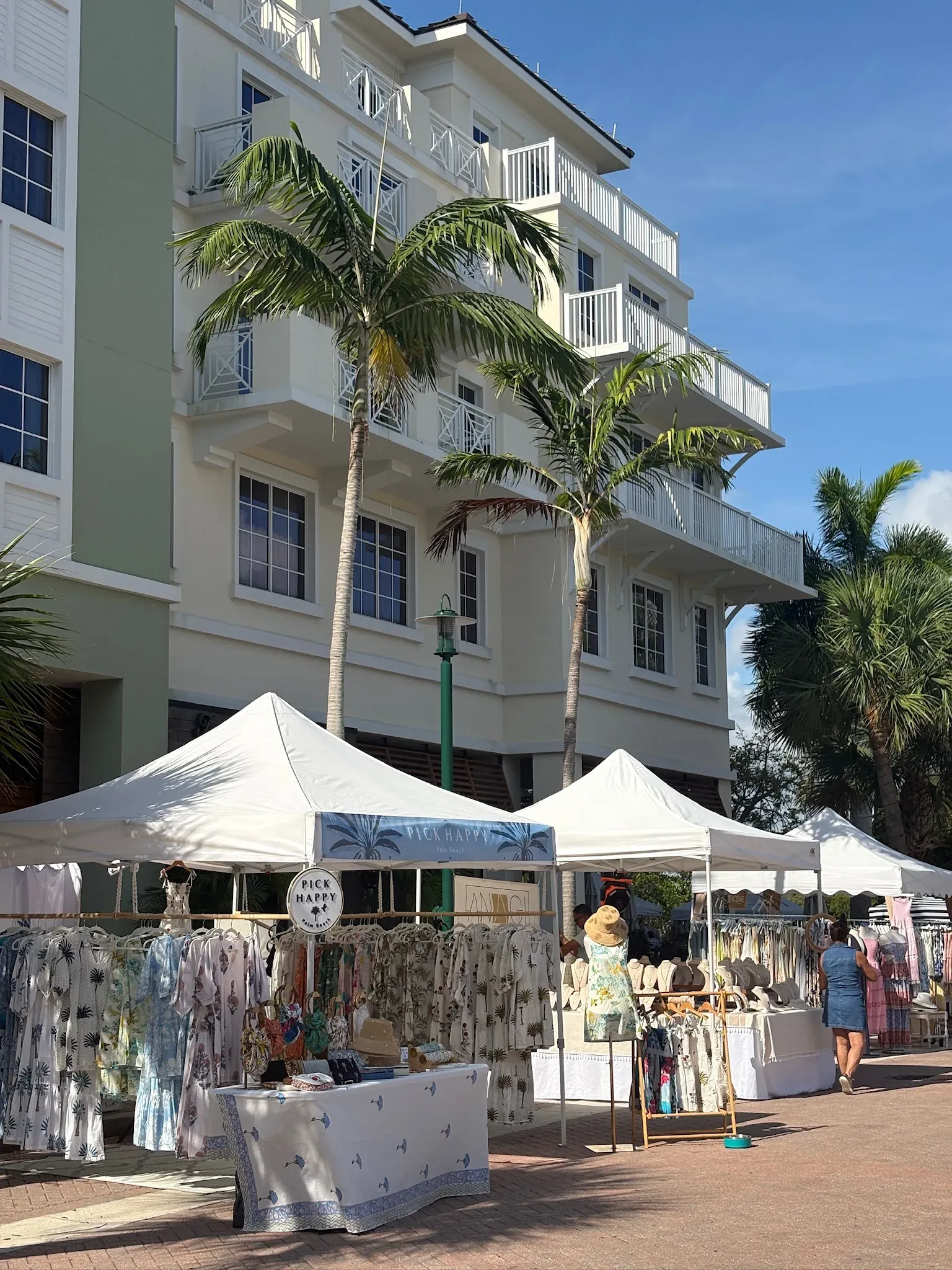 A bustling market scene with vendors and shoppers at Harbourside Place.