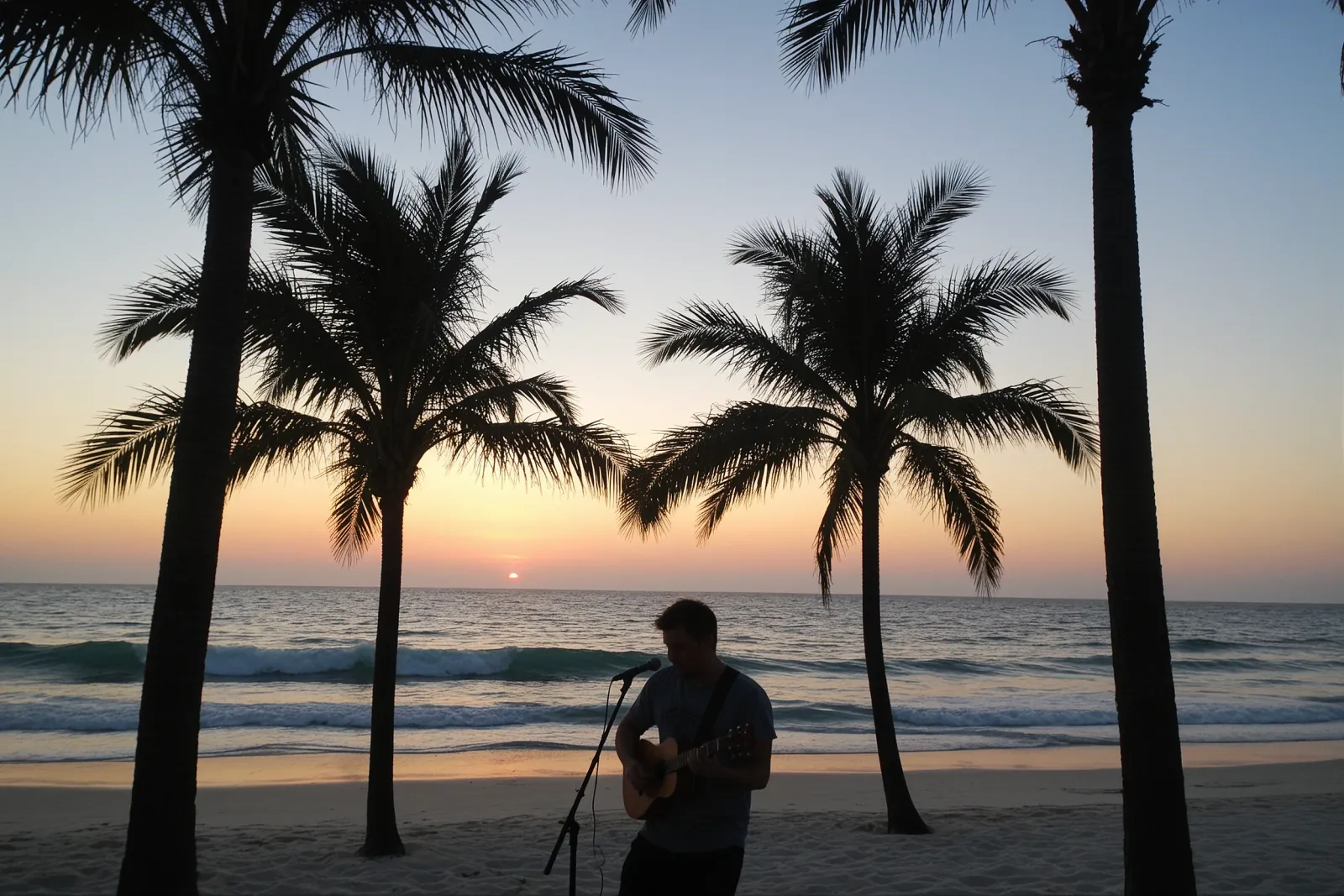 A musician performing on stage with a ukulele at an outdoor venue.