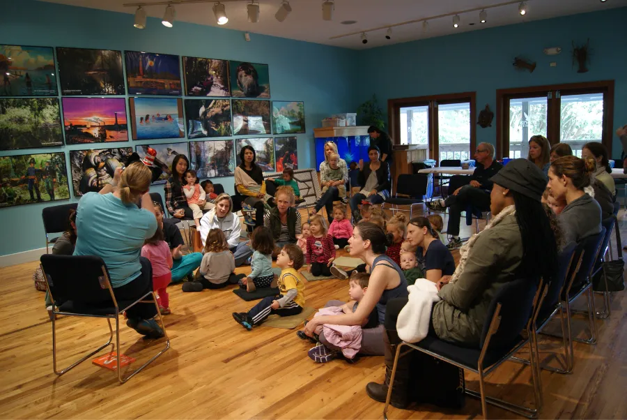 Children and an animal ambassador during a Story Time event at the Loxahatchee River Center.