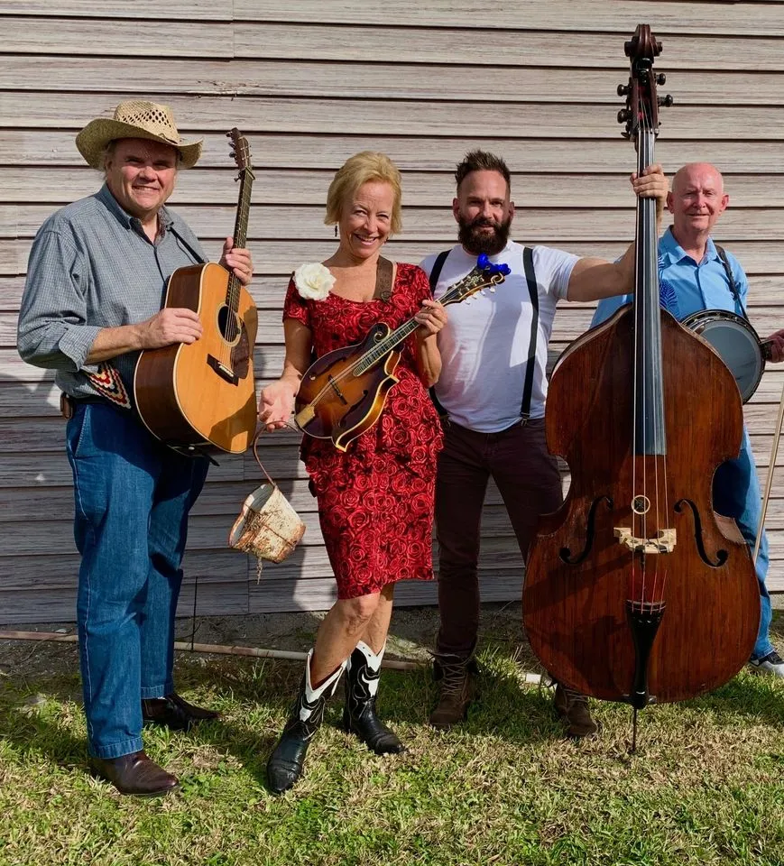 A band performing live folk music on an outdoor stage at a state park.